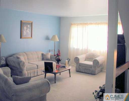 7005 Hana Road Edison, NJ 08817 - Photo 2 of 8 a living room with furniture and a flat screen tv