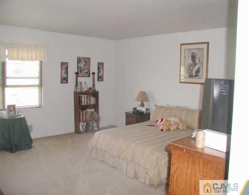 7005 Hana Road Edison, NJ 08817 - Photo 5 of 8 a bedroom with a bed and a window