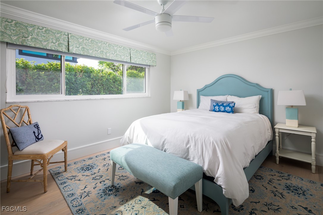 635 Fountainhead Lane Naples, FL 34103 - Photo 18 of 28 a bedroom with a bed and a window