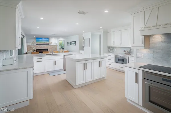 a kitchen with cabinets a sink and a stove top oven