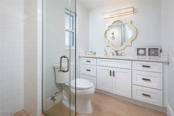 a bathroom with a toilet a sink and a mirror