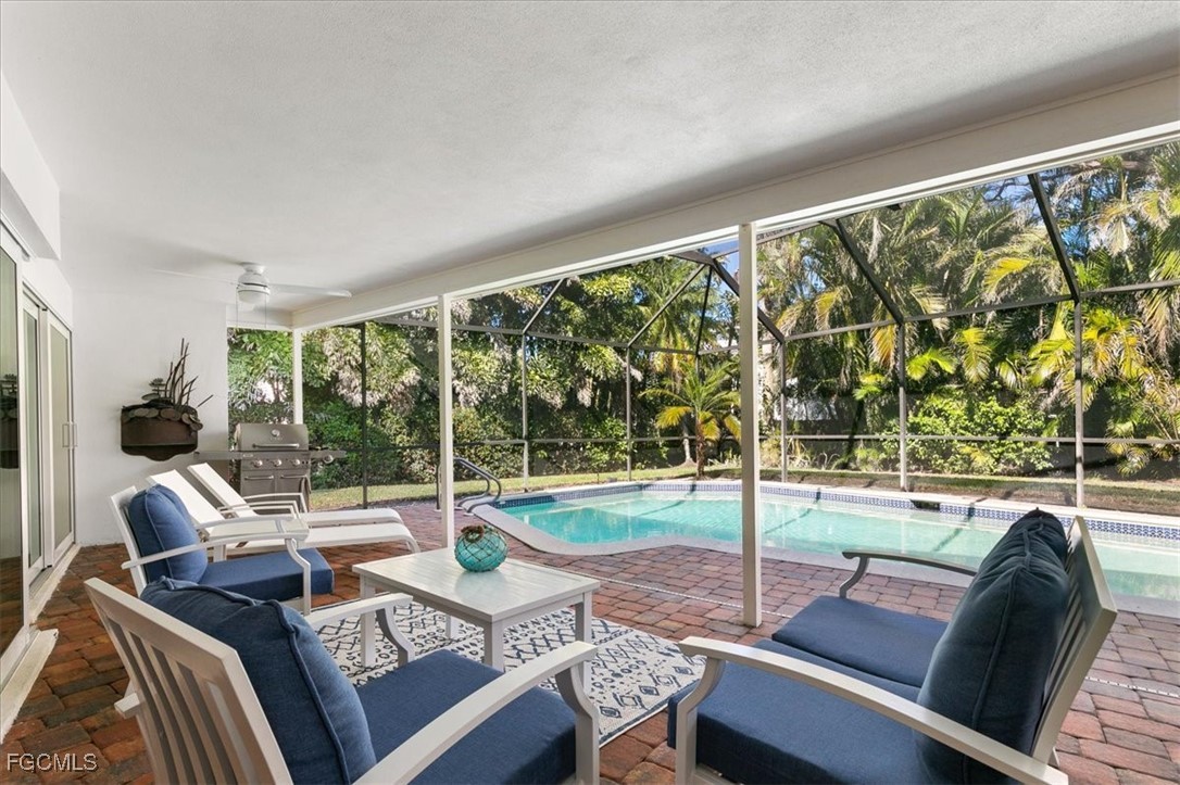 635 Fountainhead Lane Naples, FL 34103 - Photo 23 of 28 a living room with furniture and a large window