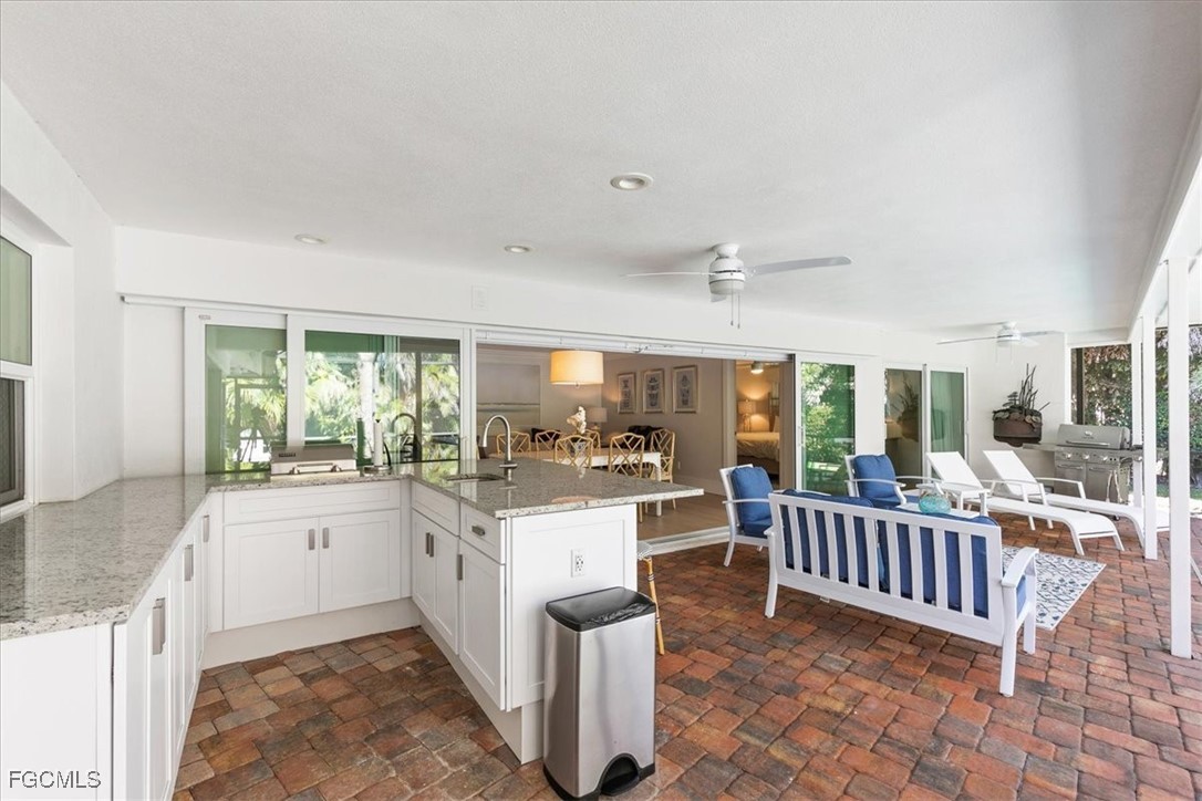 635 Fountainhead Lane Naples, FL 34103 - Photo 25 of 28 a kitchen with counter top space and wooden floor