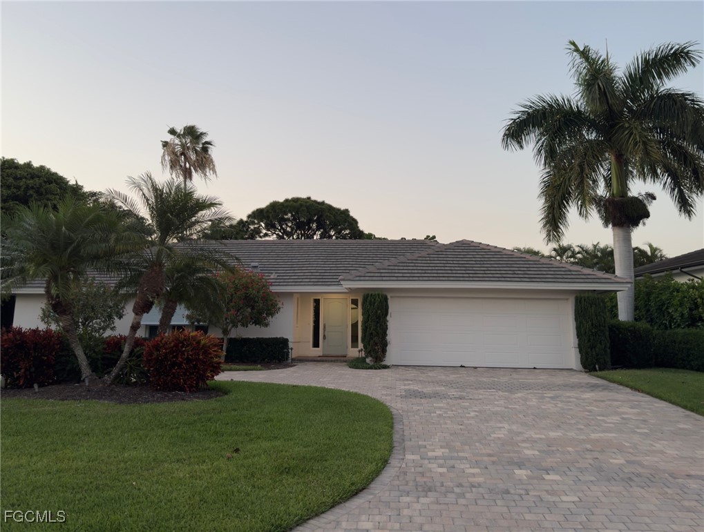 635 Fountainhead Lane Naples, FL 34103 - Photo 28 of 28 a front view of a house with a garden