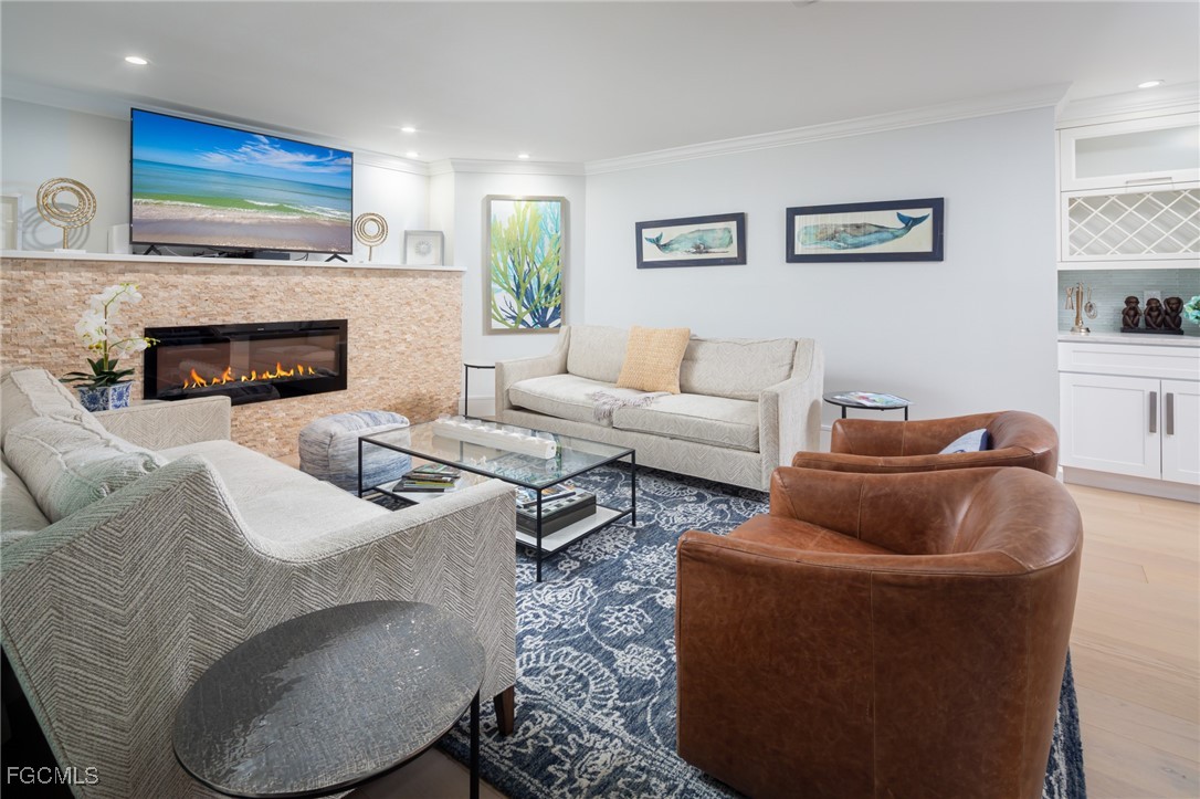635 Fountainhead Lane Naples, FL 34103 - Photo 5 of 28 a living room with furniture and a fireplace