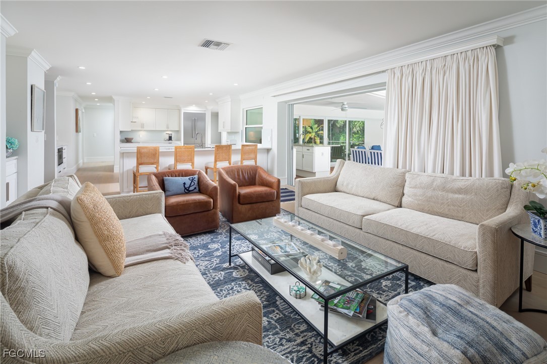 635 Fountainhead Lane Naples, FL 34103 - Photo 9 of 28 a living room with furniture and a large window