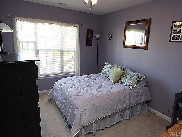 8333 Tie Stone Way Raleigh, NC 27613 - Photo 11 of 12 a bedroom with a bed and a window
