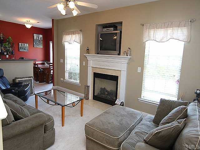 8333 Tie Stone Way Raleigh, NC 27613 - Photo 4 of 12 a living room with furniture and a fireplace