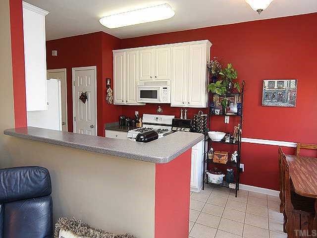 8333 Tie Stone Way Raleigh, NC 27613 - Photo 7 of 12 a kitchen with a sink and cabinets