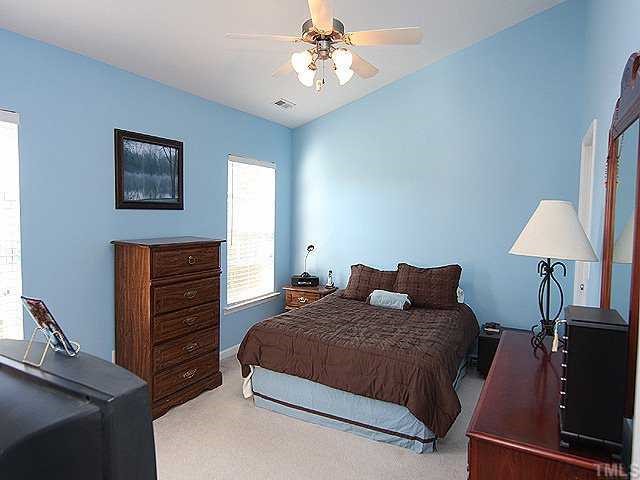 8333 Tie Stone Way Raleigh, NC 27613 - Photo 9 of 12 a bedroom with a bed and dresser