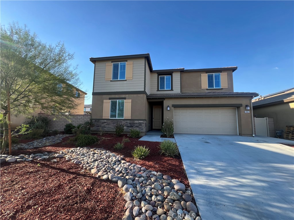 a front view of a house with a yard and garage