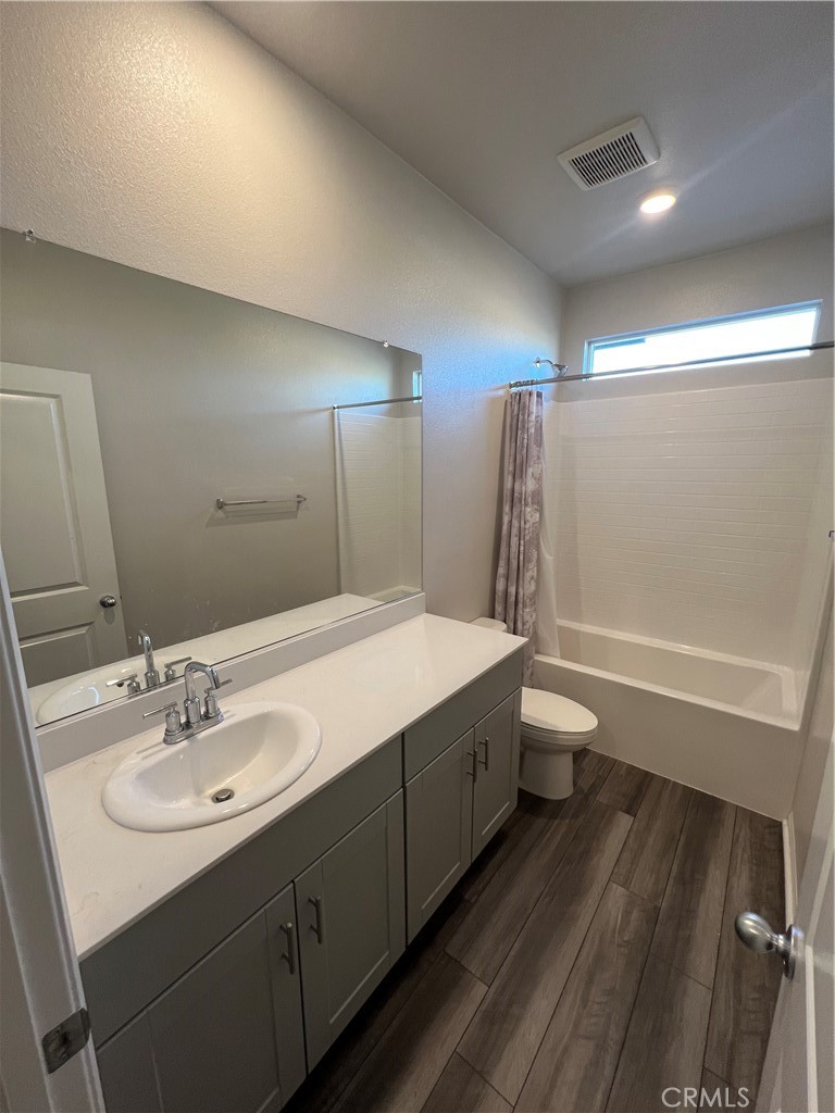29837 Warrior Way Menifee, CA 92584 - Photo 12 of 18 a bathroom with a sink a toilet a shower and a mirror