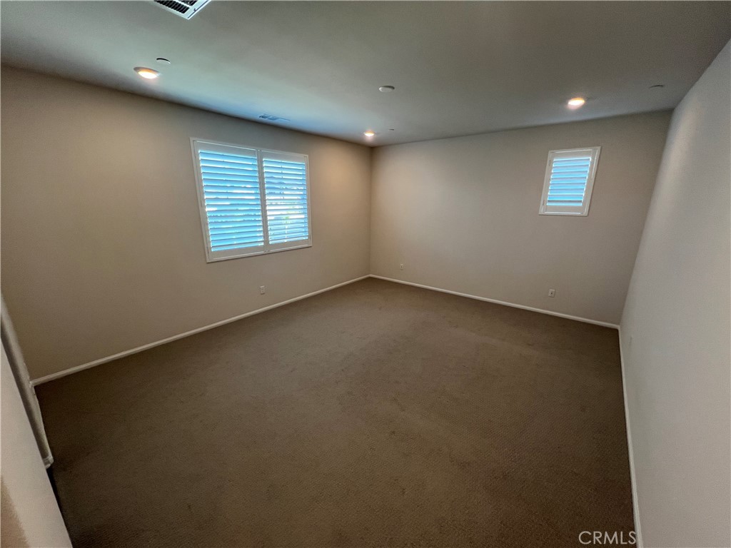 29837 Warrior Way Menifee, CA 92584 - Photo 13 of 18 an empty room with windows