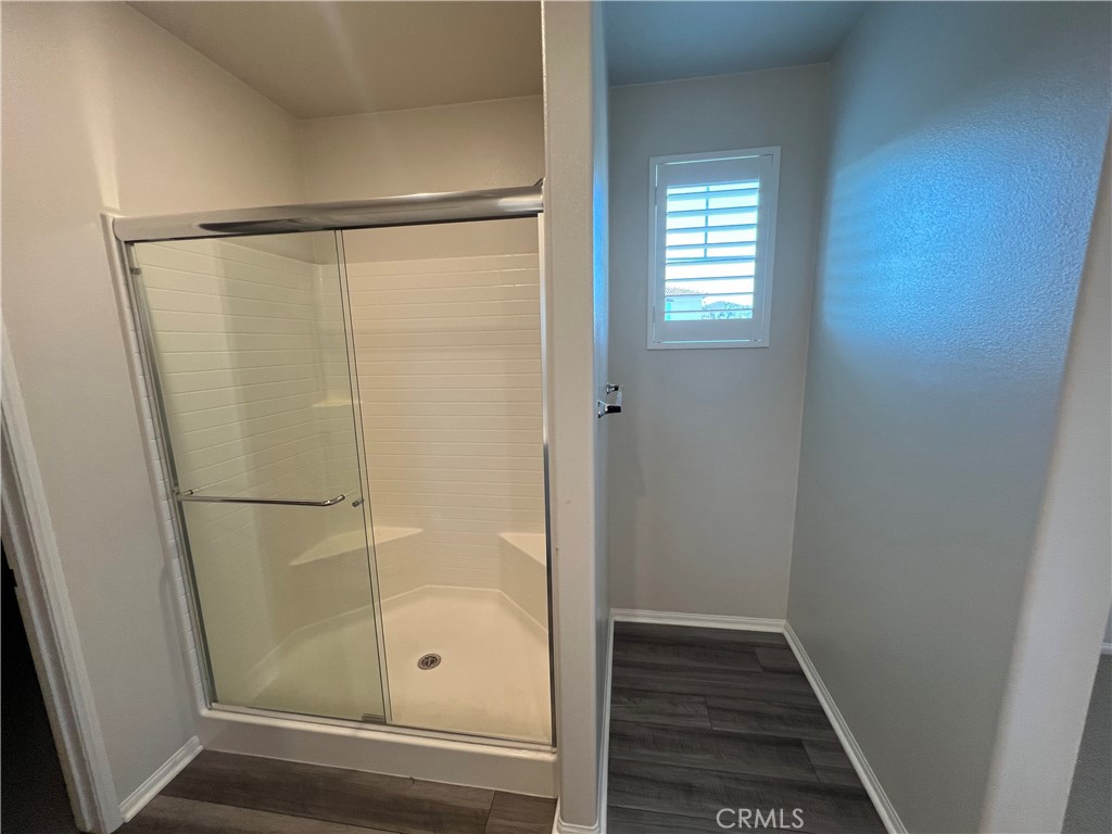 29837 Warrior Way Menifee, CA 92584 - Photo 15 of 18 a bathroom with a glass shower door