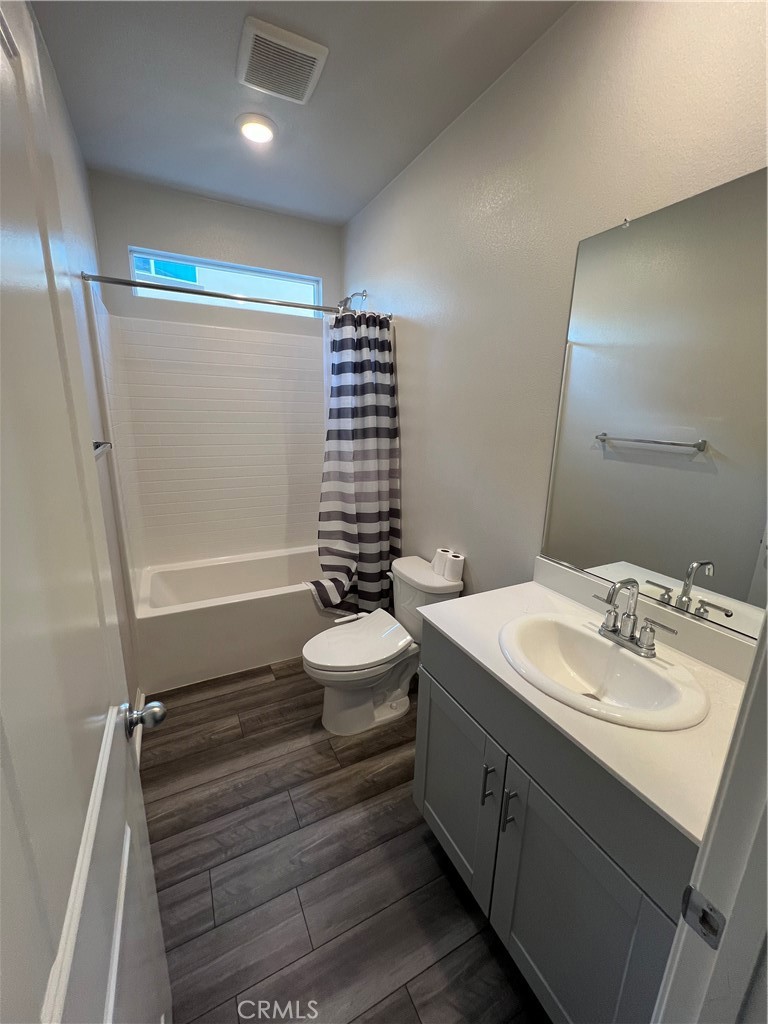 29837 Warrior Way Menifee, CA 92584 - Photo 7 of 18 a bathroom with a sink a toilet and shower