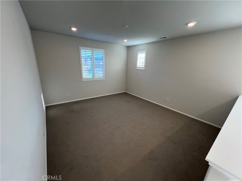 29837 Warrior Way Menifee, CA 92584 - Photo 9 of 18 an empty room with windows