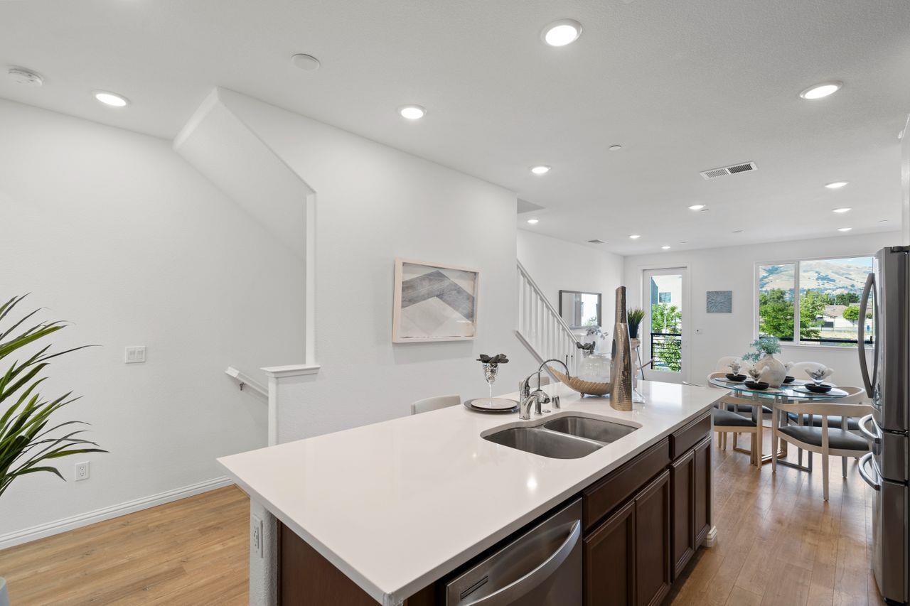 718 Fruit Ranch Loop San Jose, CA 95133 - Photo 13 of 36 a kitchen with a sink a counter and chairs
