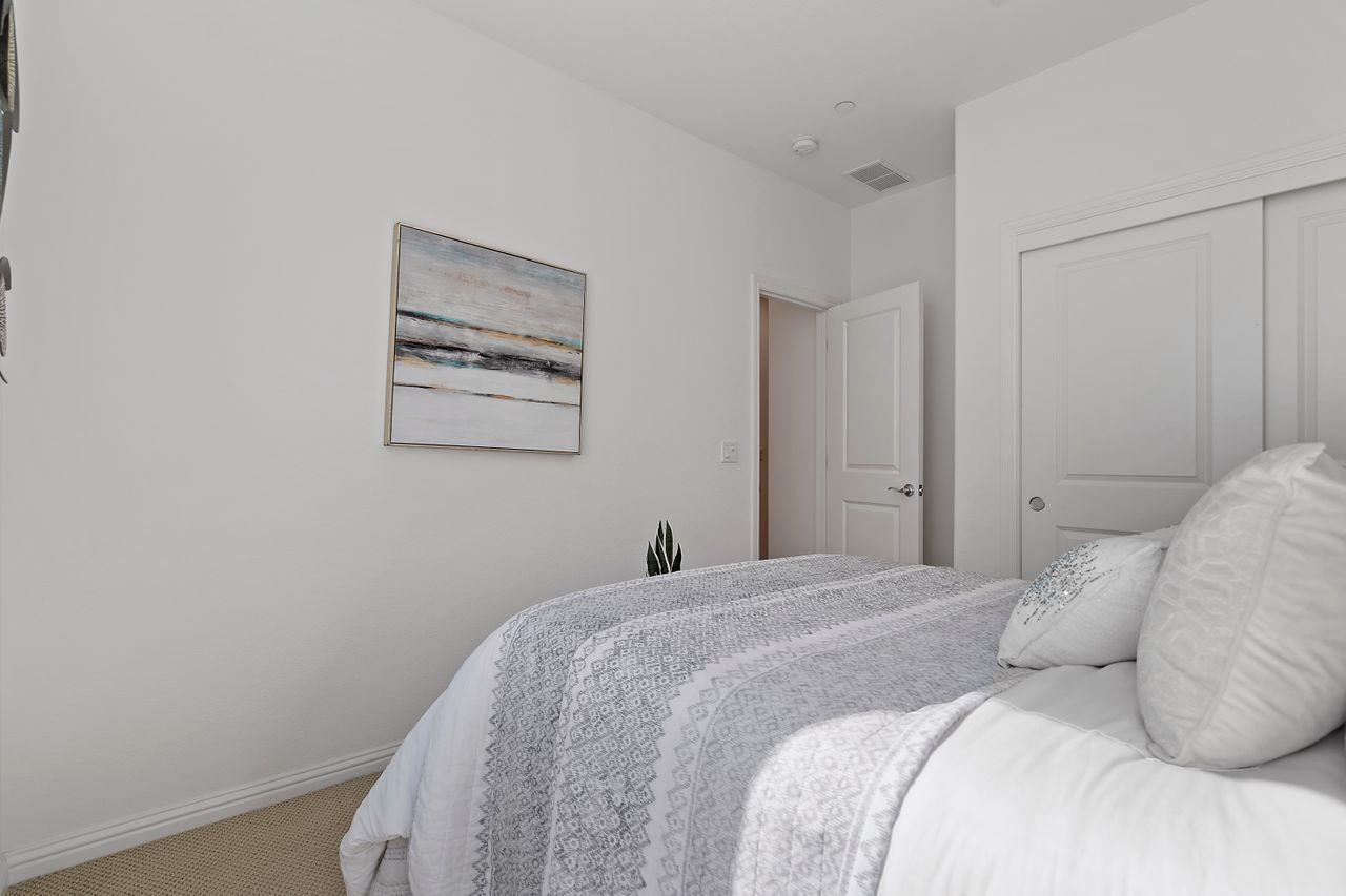 718 Fruit Ranch Loop San Jose, CA 95133 - Photo 16 of 36 a bedroom with a bed and a painting on the wall
