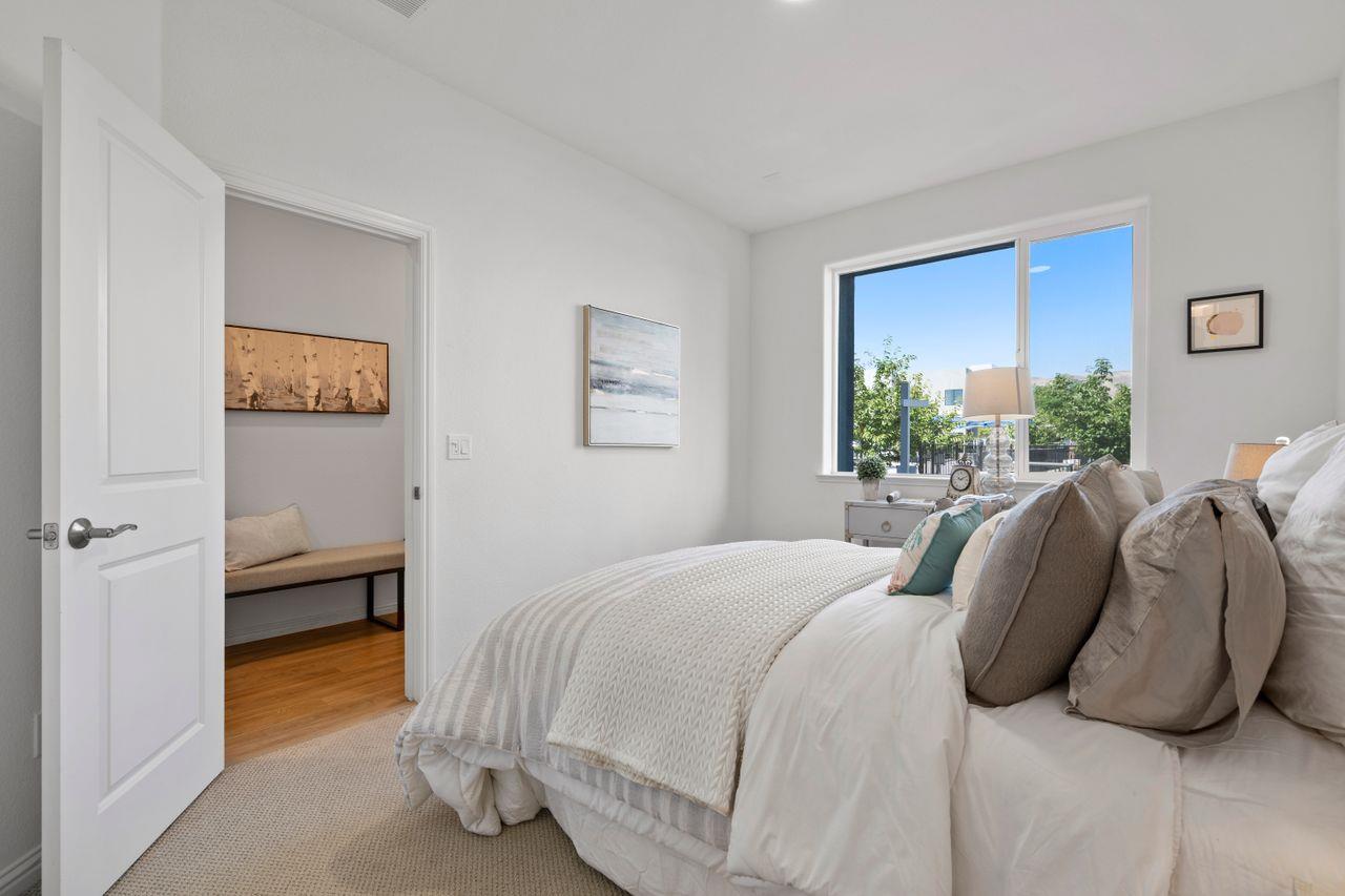 718 Fruit Ranch Loop San Jose, CA 95133 - Photo 18 of 36 a bedroom with a bed and a lamp