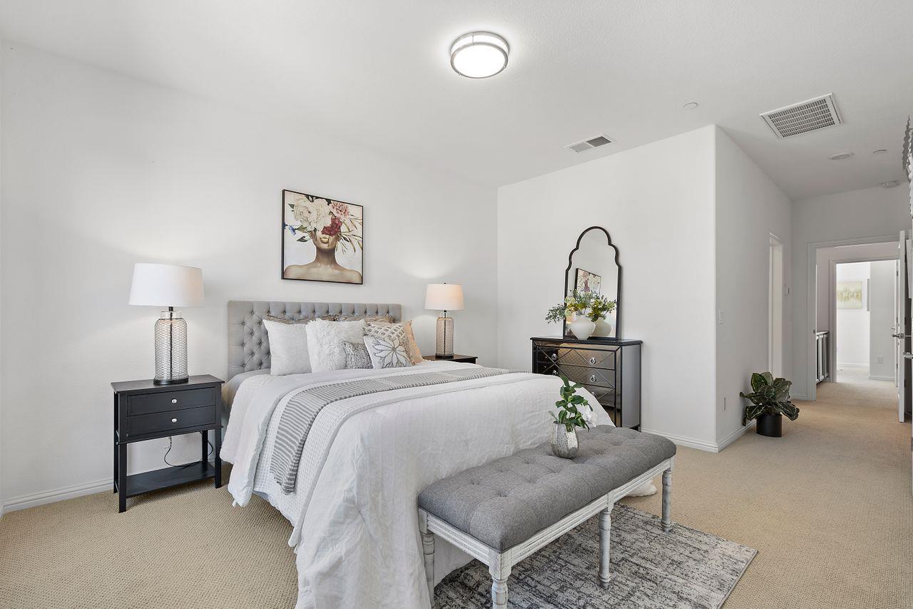 718 Fruit Ranch Loop San Jose, CA 95133 - Photo 23 of 36 a bed room with a bed and a lamp