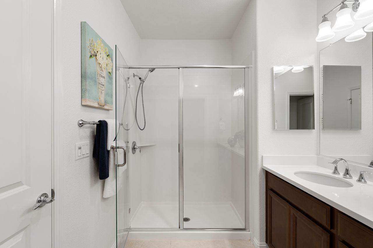 718 Fruit Ranch Loop San Jose, CA 95133 - Photo 25 of 36 a bathroom with a shower sink and mirror
