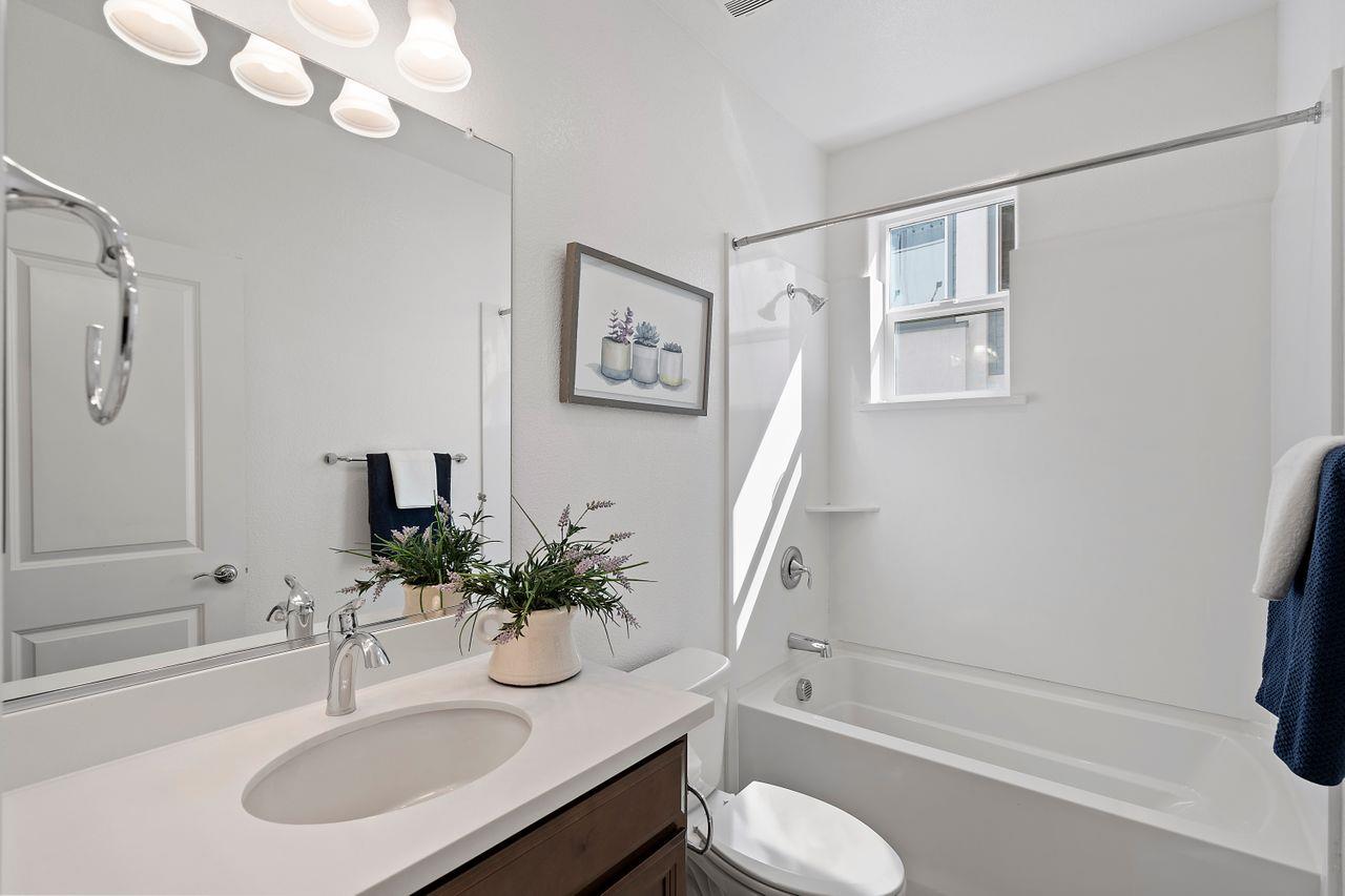 718 Fruit Ranch Loop San Jose, CA 95133 - Photo 29 of 36 a bathroom with a sink a toilet and a mirror