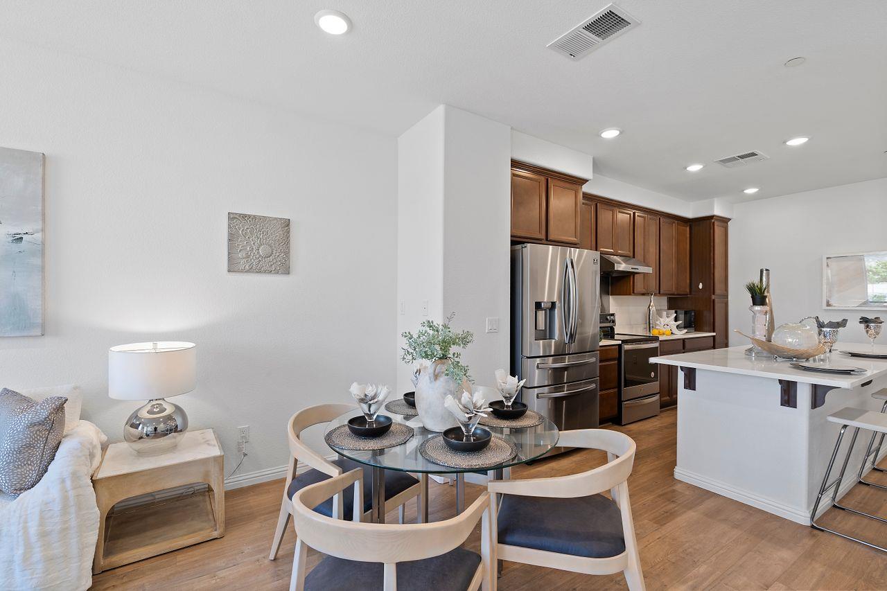 718 Fruit Ranch Loop San Jose, CA 95133 - Photo 5 of 36 a kitchen with stainless steel appliances kitchen island granite countertop a kitchen island a stove a table and chairs