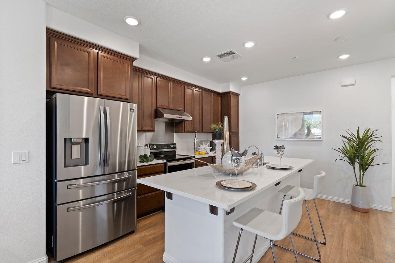 718 Fruit Ranch Loop San Jose, CA 95133 - Photo 10 of 36 a kitchen with refrigerator a microwave and cabinets