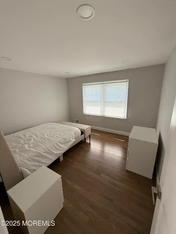 a bathroom with a sink a window and mirror