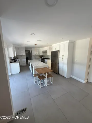 a room with furniture and a kitchen view