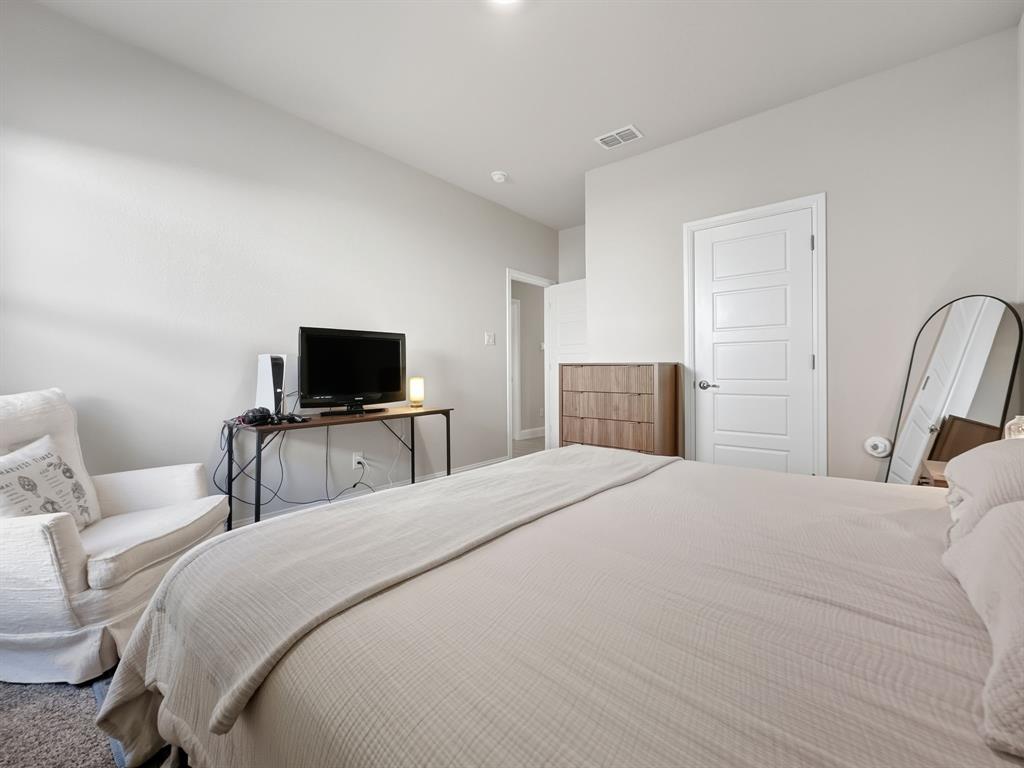 2216 Redwing Drive Denton, TX 76205 - Photo 27 of 38 a bedroom with a bed and a television