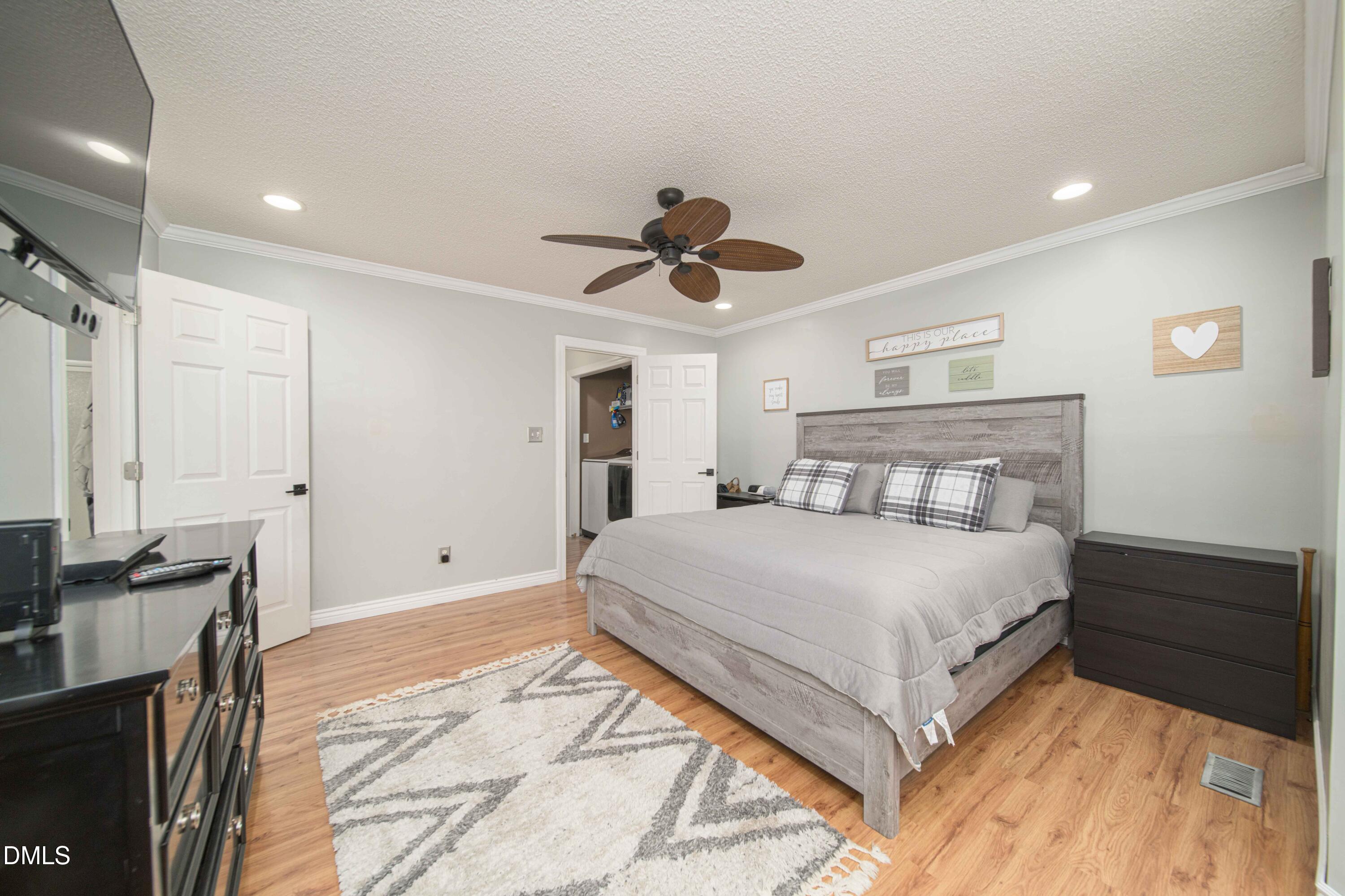 4411 Lessie Trail Rocky Mount, NC 27804 - Photo 11 of 27 a bedroom with a bed and a chandelier