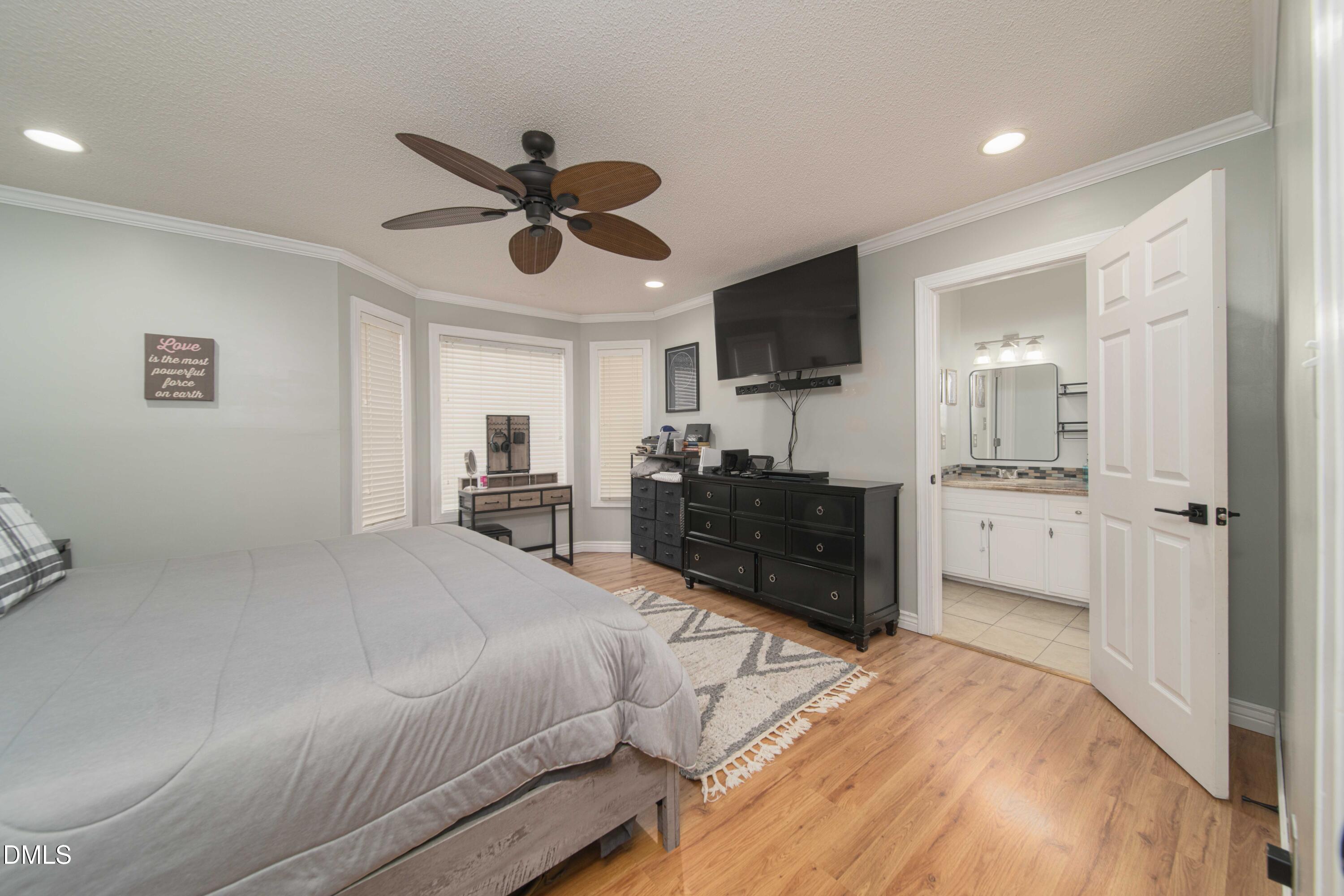 4411 Lessie Trail Rocky Mount, NC 27804 - Photo 12 of 27 a large bedroom with a bed and a flat screen tv