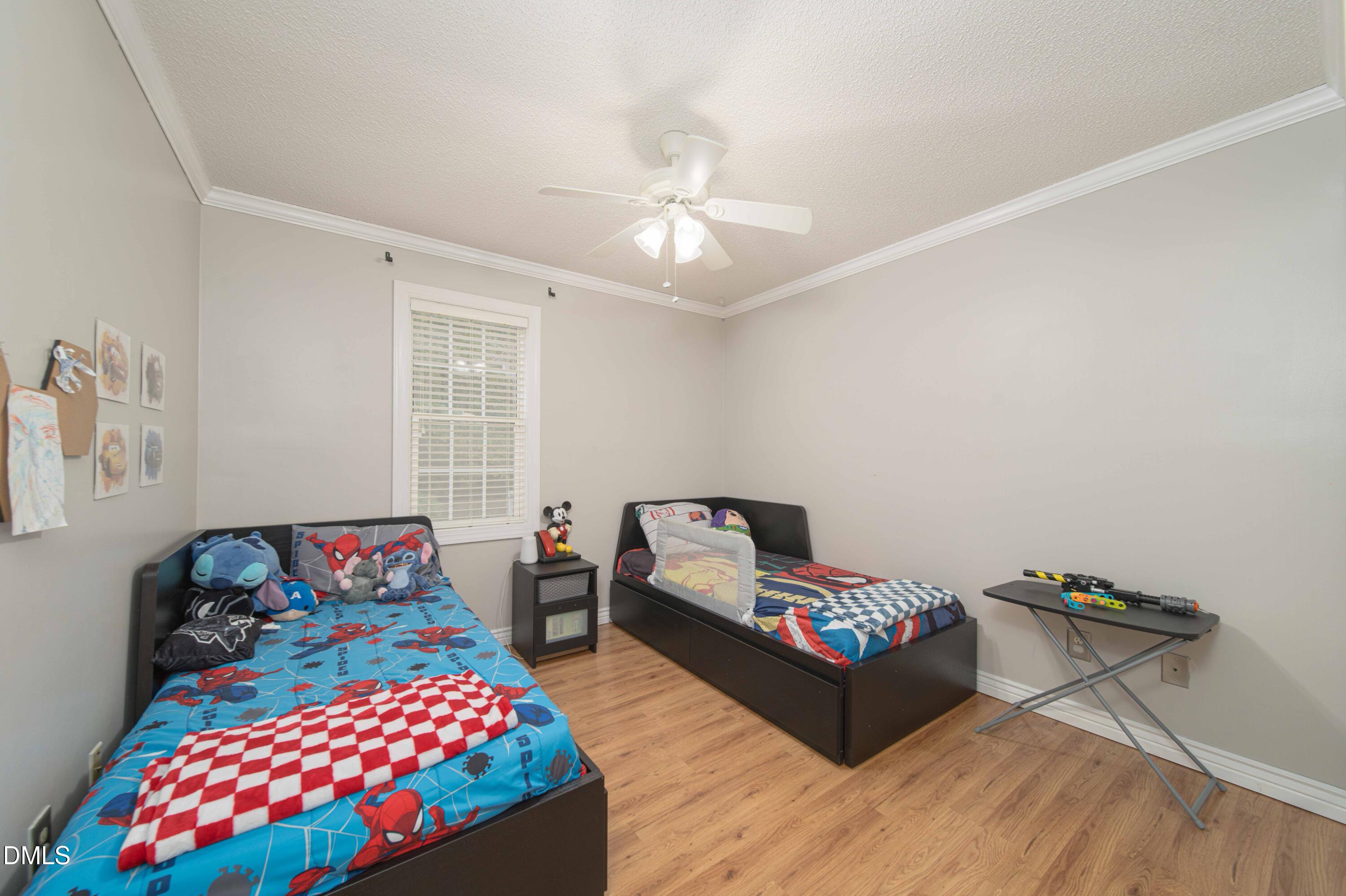 4411 Lessie Trail Rocky Mount, NC 27804 - Photo 16 of 27 a bedroom with furniture and a chandelier