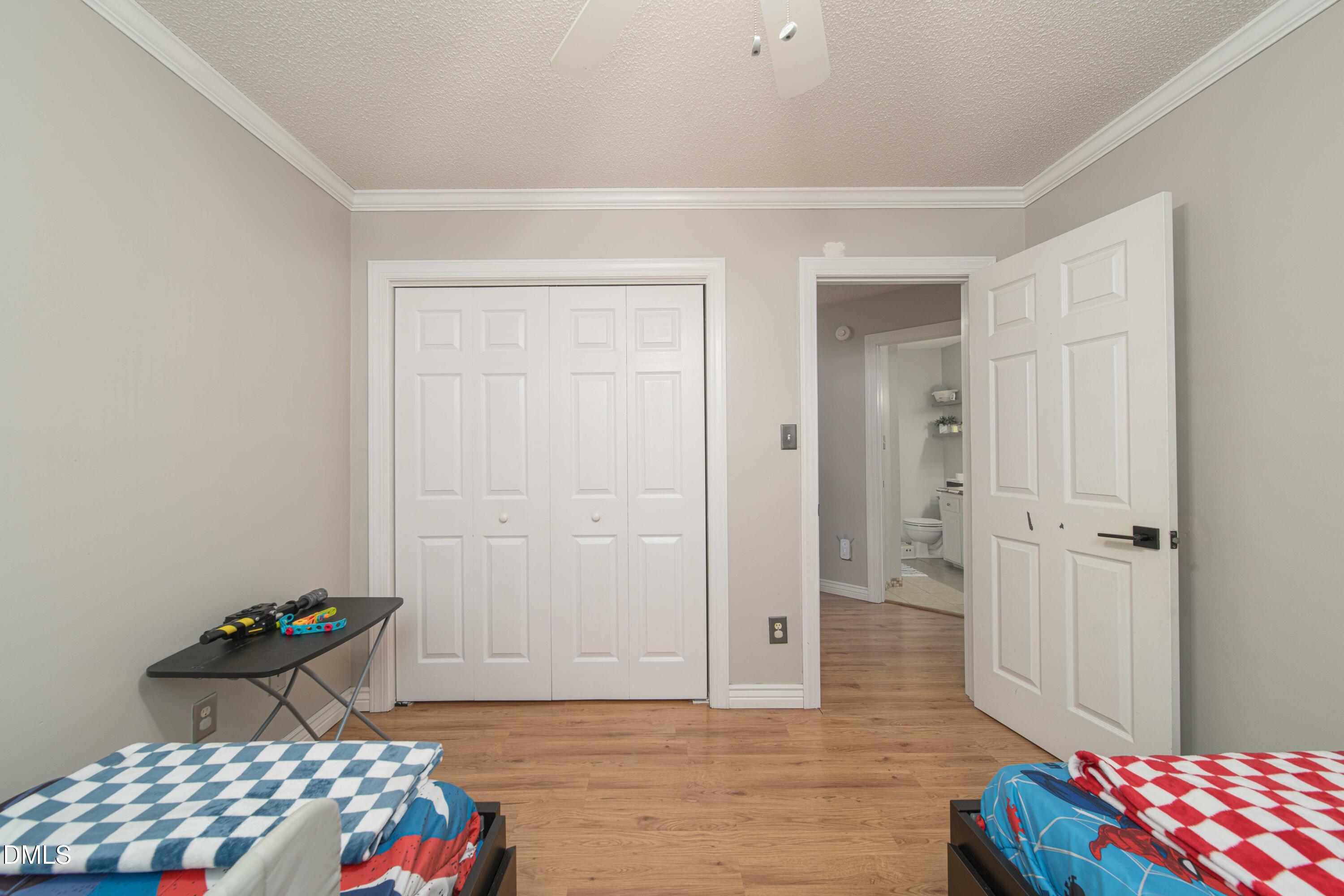 4411 Lessie Trail Rocky Mount, NC 27804 - Photo 17 of 27 a bedroom with a bed and wooden floor