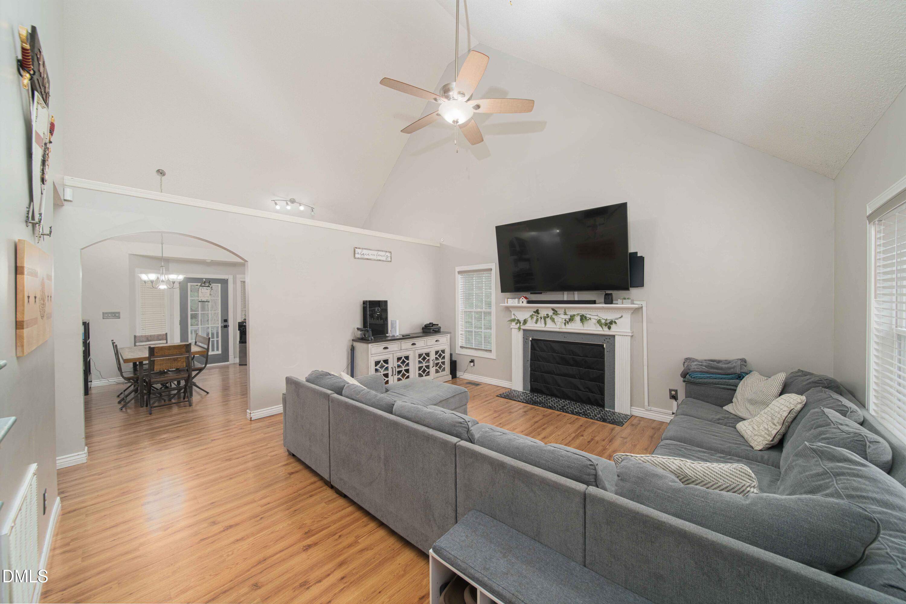 4411 Lessie Trail Rocky Mount, NC 27804 - Photo 4 of 27 a living room with furniture a fireplace and a flat screen tv