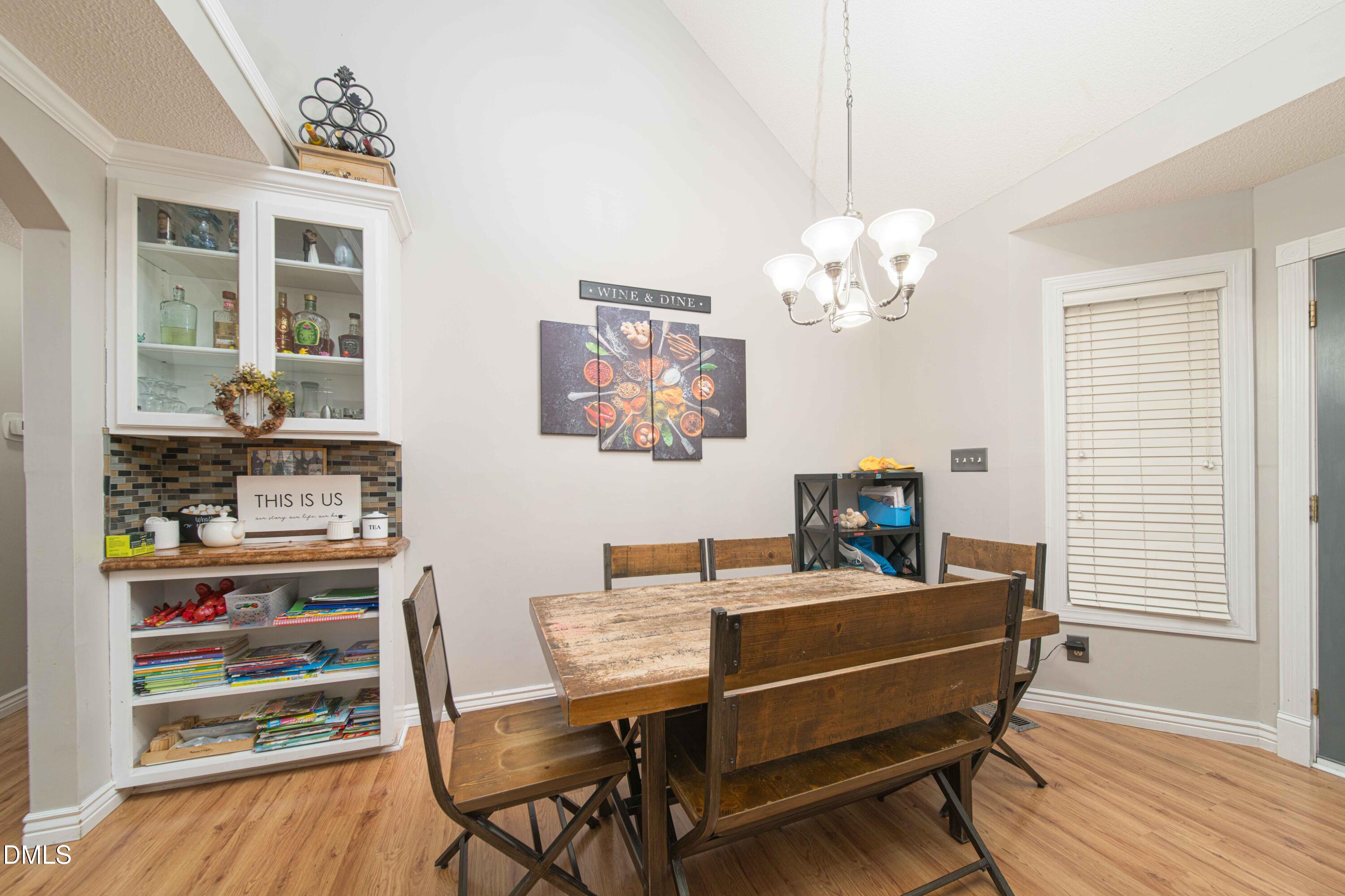 4411 Lessie Trail Rocky Mount, NC 27804 - Photo 8 of 27 a view of a dining room with furniture and wooden floor