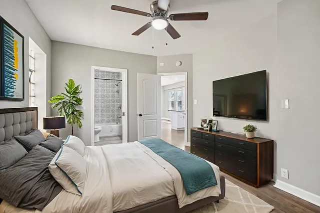 a bedroom with a bed and a flat screen tv