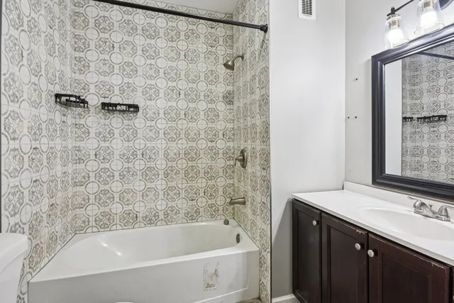 a bathroom with a bathtub and a sink