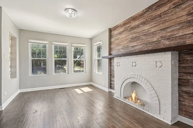 a view of livingroom with furniture a fireplace and wooden floor