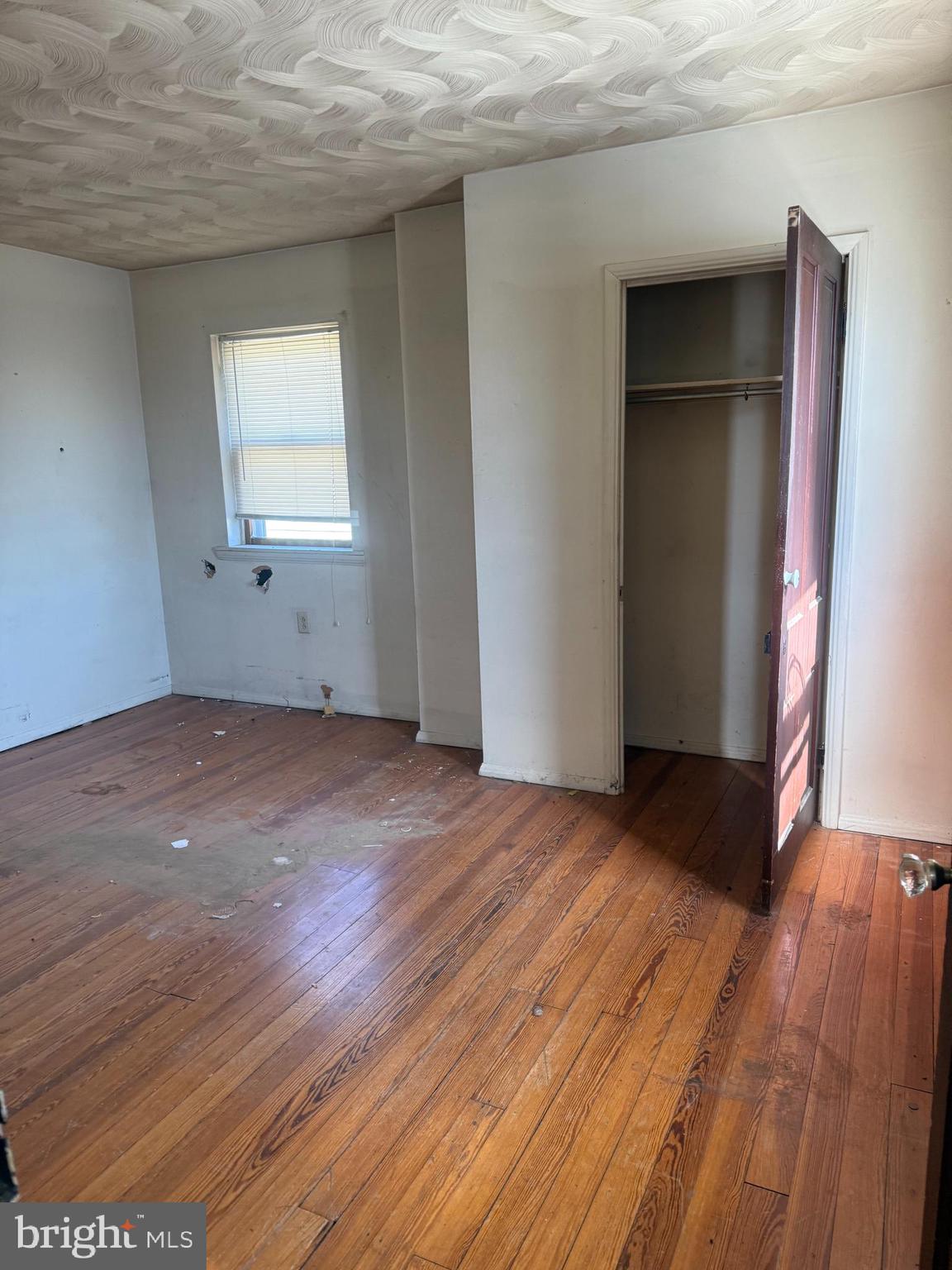 122 West 4th Avenue Ranson, WV 25438 - Photo 7 of 9 an empty room with wooden floor and windows