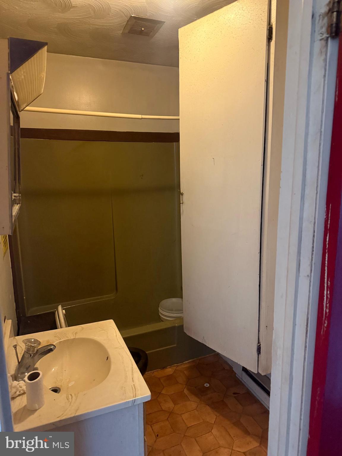 122 West 4th Avenue Ranson, WV 25438 - Photo 9 of 9 a bathroom with a sink and a toilet