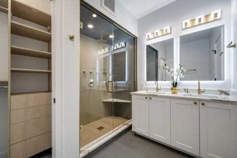 a bathroom with a double vanity sink and a mirror