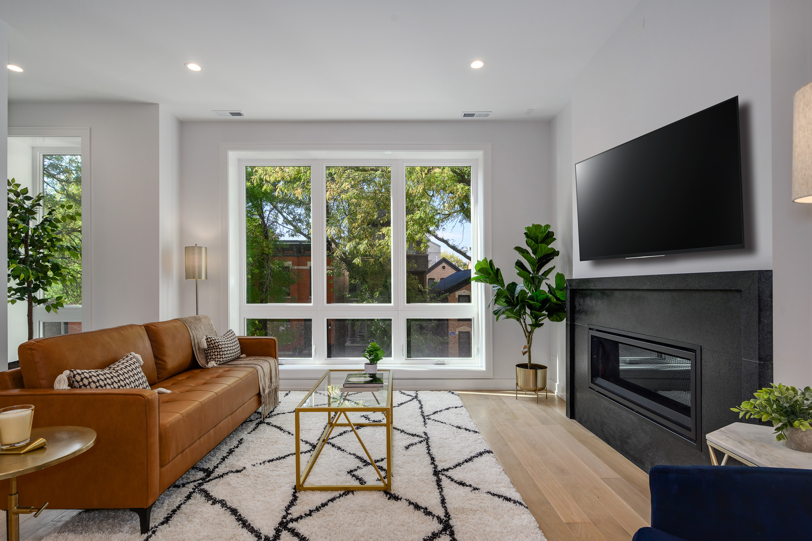 867 North Marshfield Avenue, Unit 2 Chicago, IL 60622 - Photo 2 of 19 a living room with furniture a flat screen tv and a fireplace