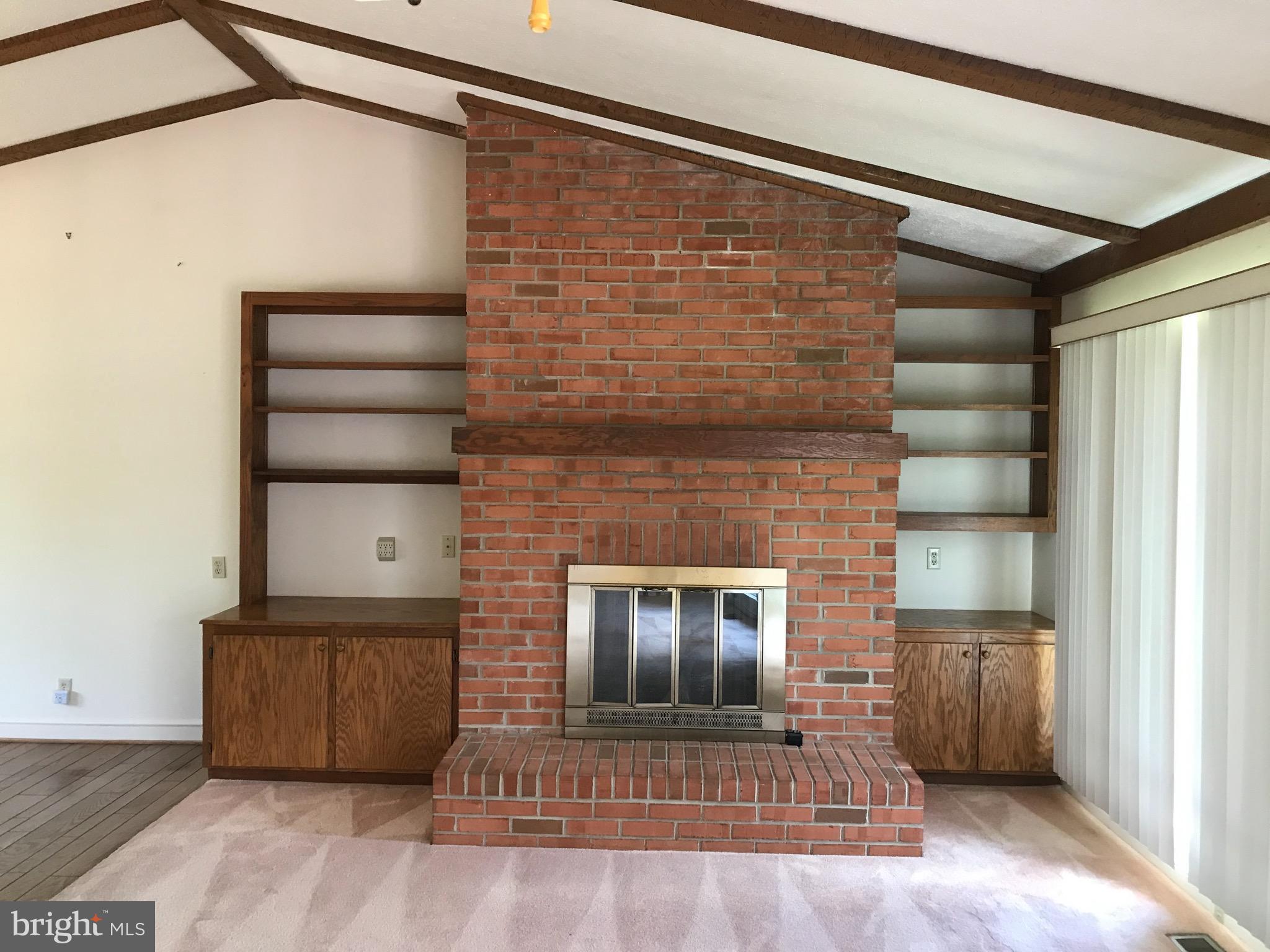 19321 Old Orange Road Culpeper, VA 22701 - Photo 17 of 28 Brick fireplace with gas logs and bookcase
