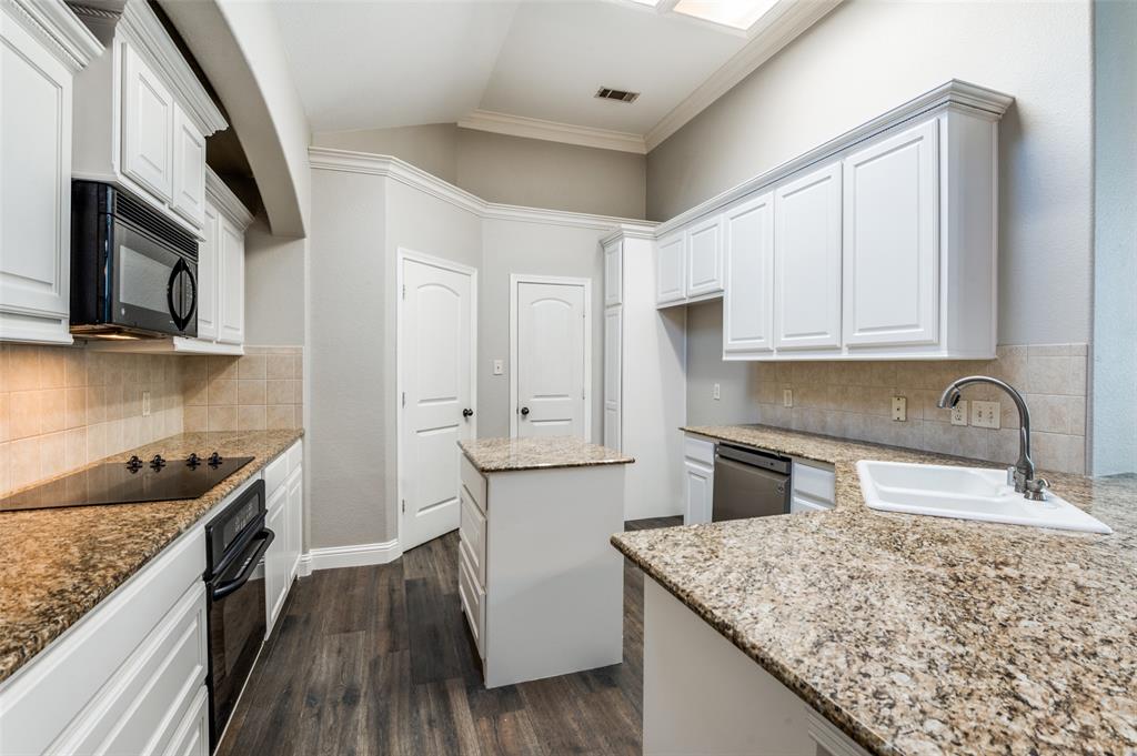 3230 Adirondack Lane Frisco, TX 75033 - Photo 14 of 27 a kitchen with stainless steel appliances granite countertop a sink stove microwave and cabinets