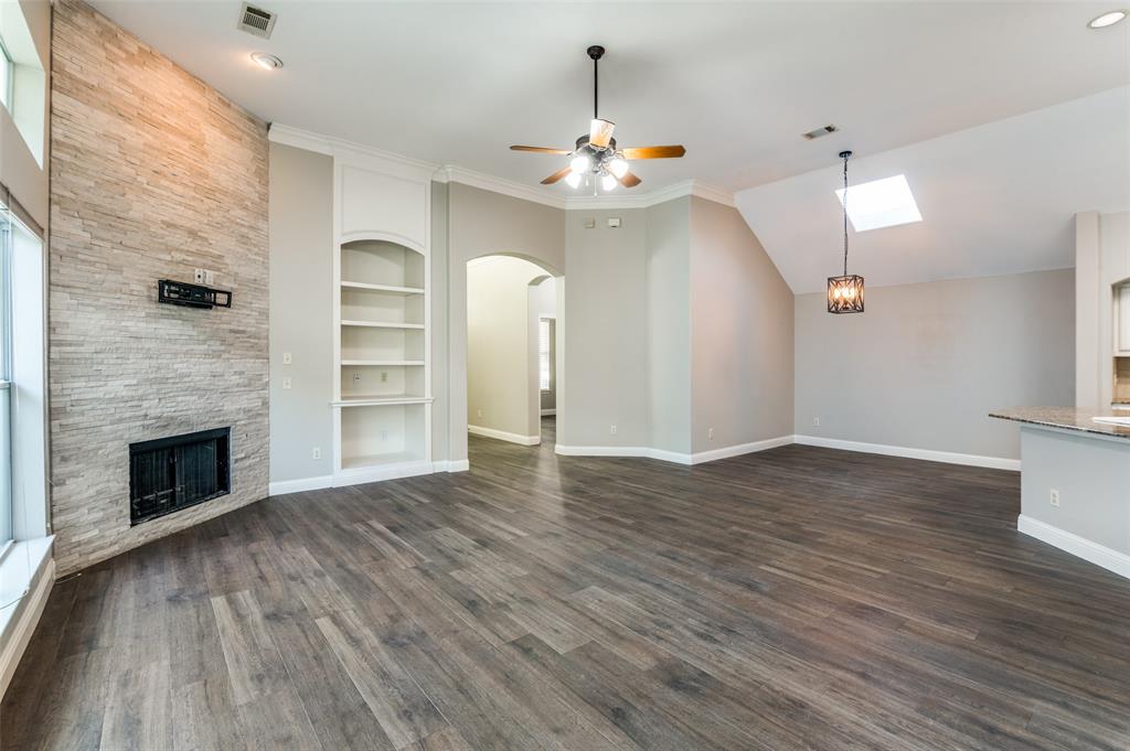 3230 Adirondack Lane Frisco, TX 75033 - Photo 3 of 27 a view of an empty room with wooden floor fireplace and a window