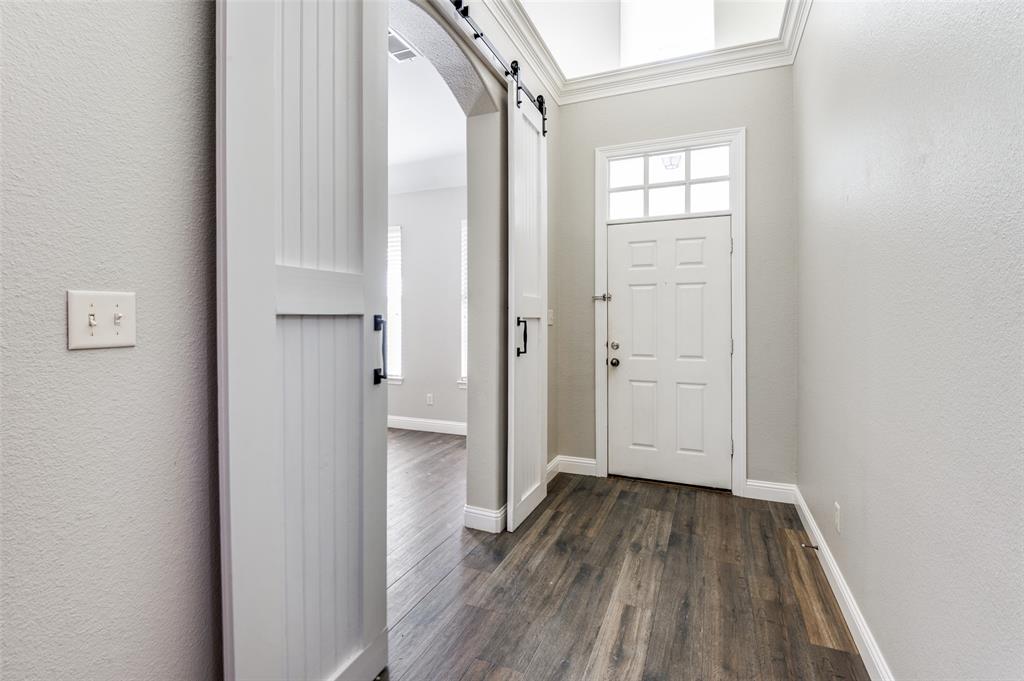 3230 Adirondack Lane Frisco, TX 75033 - Photo 5 of 27 a view of a hallway with wooden floor and a bathroom