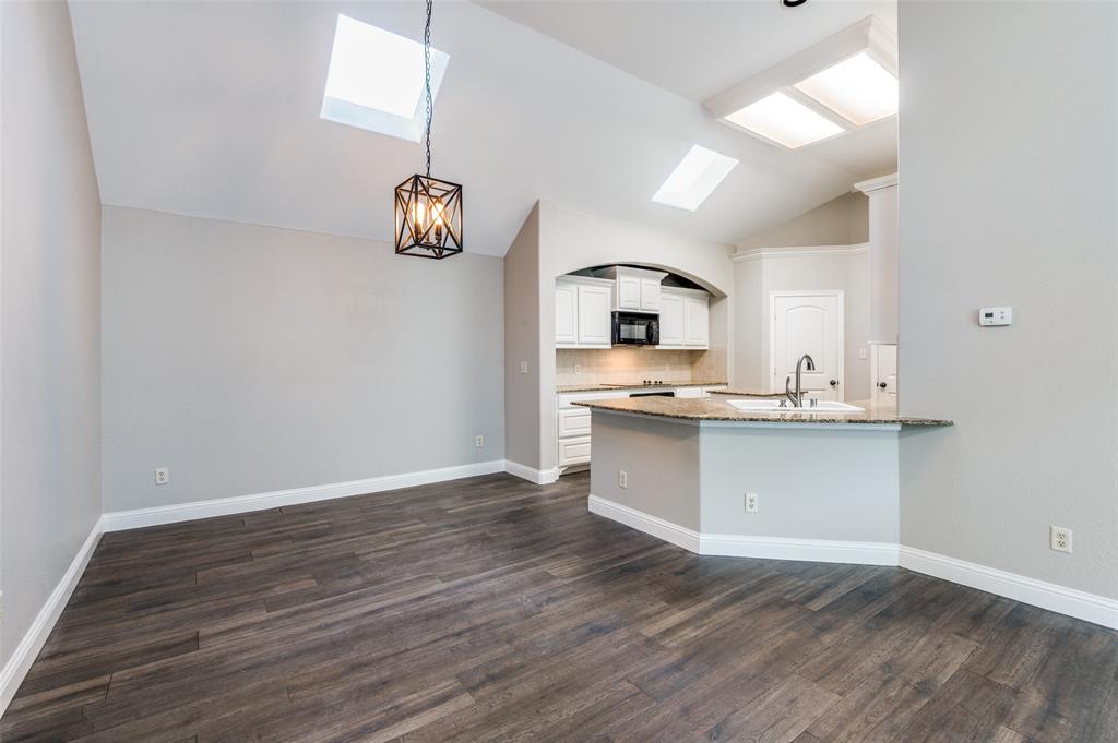 3230 Adirondack Lane Frisco, TX 75033 - Photo 10 of 27 a kitchen with granite countertop white cabinets and white appliances