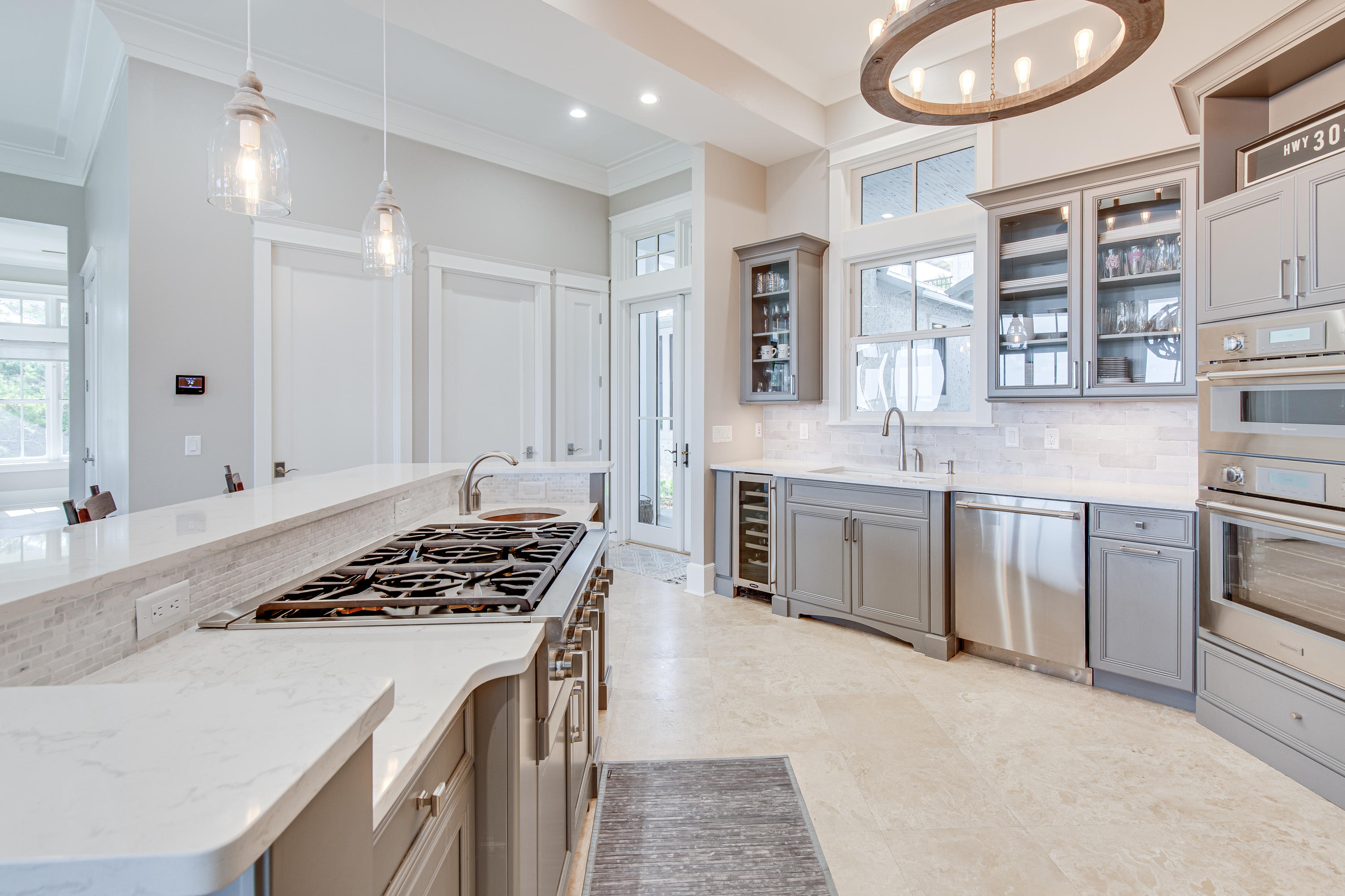201 West Bermuda Drive Santa Rosa Beach, FL 32459 - Photo 17 of 56 a kitchen with white cabinets and appliances